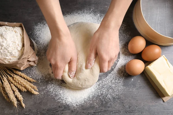 Woman kneading dough on table, closeup — Stock Photo, Image