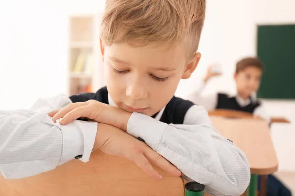 Bullied little boy in classroom — Stock Photo, Image