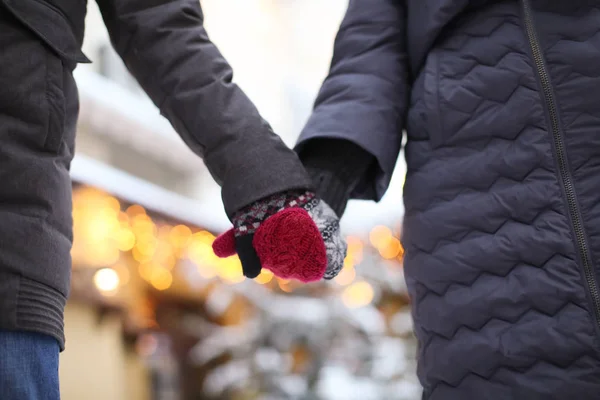 Молодая любящая пара держится за руки на улице в зимний день — стоковое фото