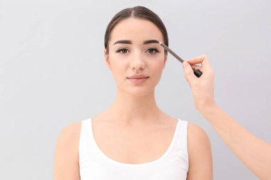 woman undergoing eyebrow correction procedure  clipart