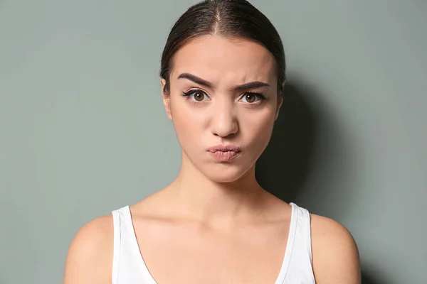 Young woman frowning eyebrows