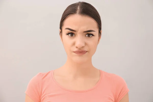 Young woman frowning eyebrows — Stock Photo, Image