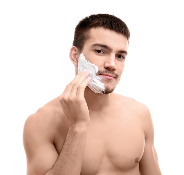 Hombre joven aplicando espuma de afeitar —  Fotos de Stock