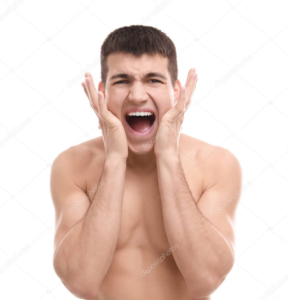 Portrait of screaming shaved young man against white background