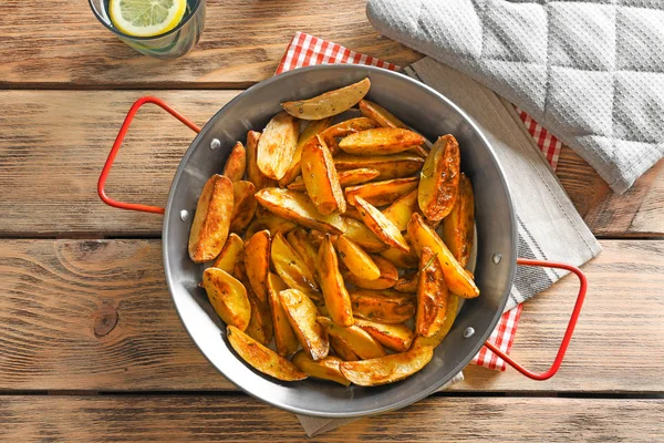 Dish with tasty potato wedges on table — Stock Photo, Image