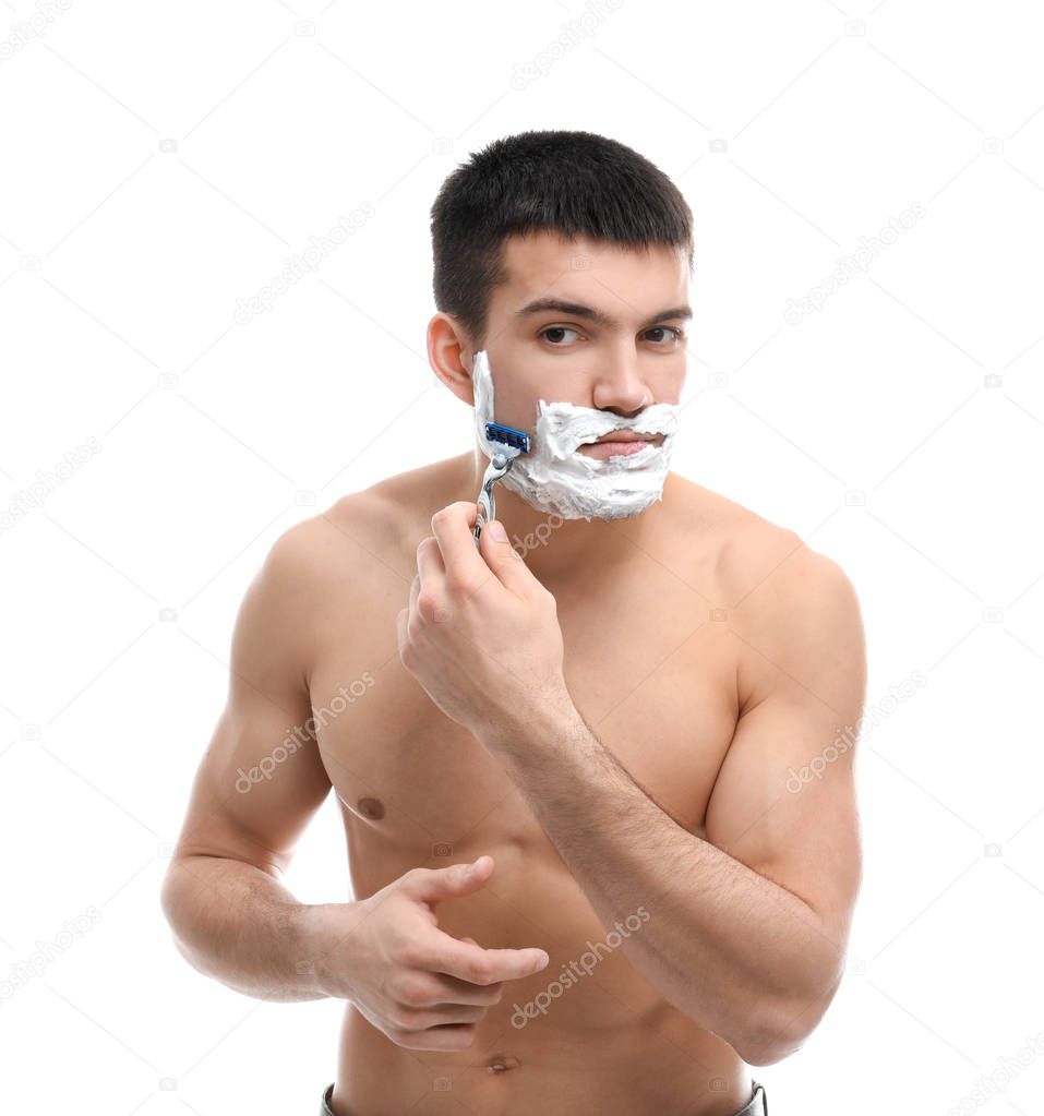 Handsome young man shaving