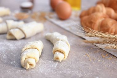 Raw croissants on table clipart