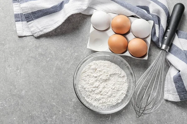 Glass Bowl Flour Eggs Whisk Grey Background — Stock Photo, Image