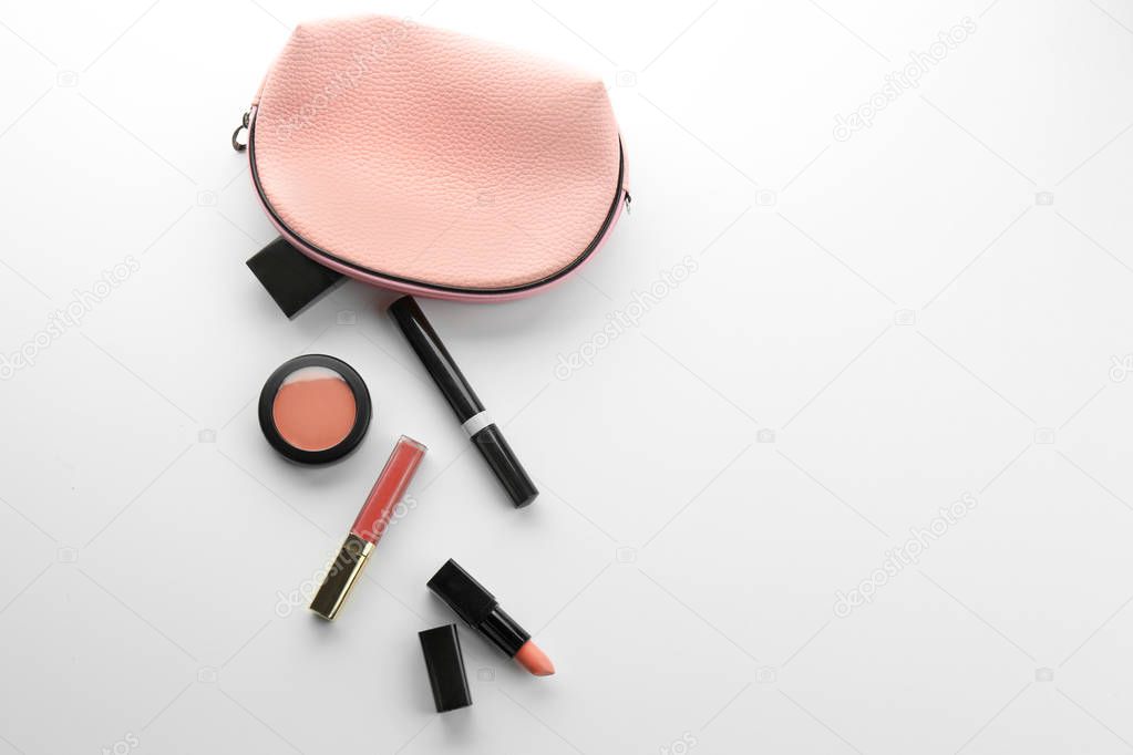 Cosmetic bag and makeup products on white background