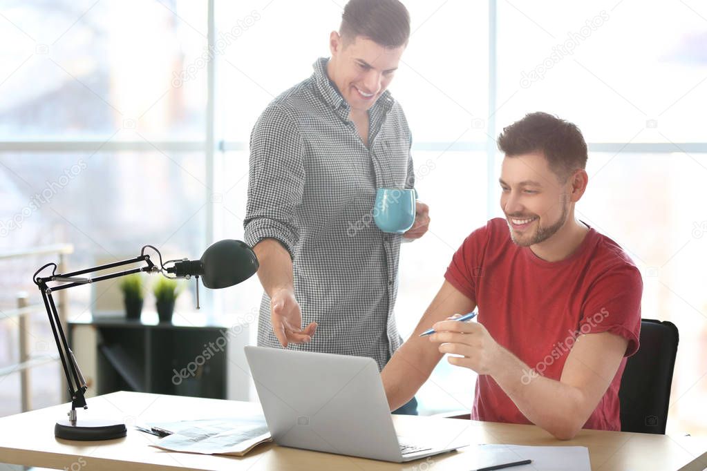 Young men with laptop indoors