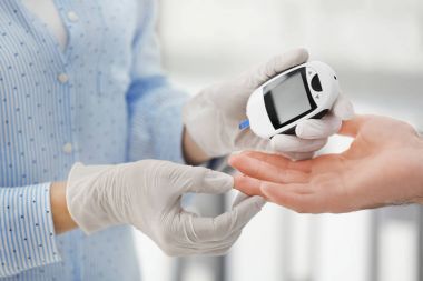 Kontrol diyabetik hastanın kan şeker seviyesi dijital Şeker Ölçüm, closeup ile doktor