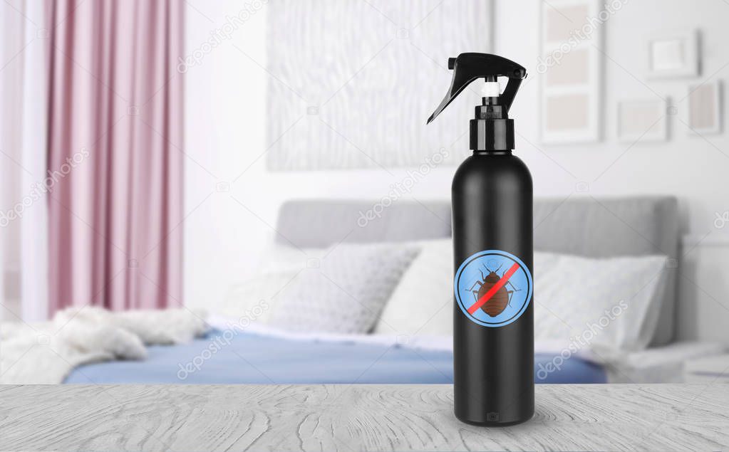 Bottle of anti bed bug detergent on table in bedroom