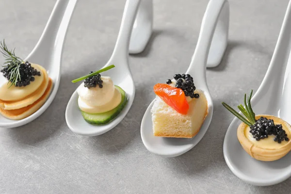 Spoons of canapes with black caviar on  table — Φωτογραφία Αρχείου