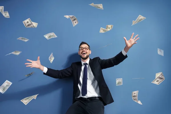 Successful stock broker with flying money on color background — Stock Photo, Image