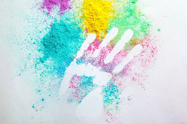 Holi festival powders and hand silhouette on white background