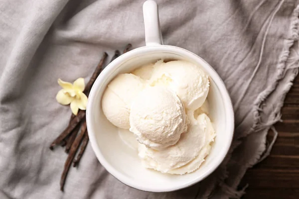 Cup with delicious vanilla ice cream on table — Stock Photo, Image