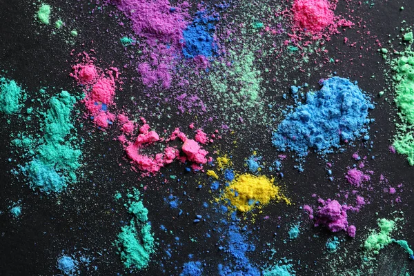 Polvos coloridos para el festival Holi sobre fondo oscuro — Foto de Stock
