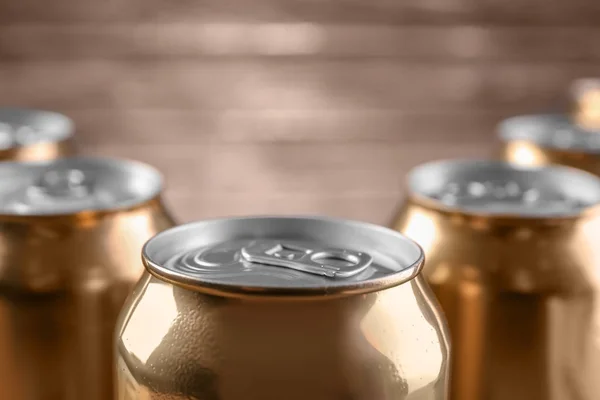 Cans of beer on blurred background, closeup