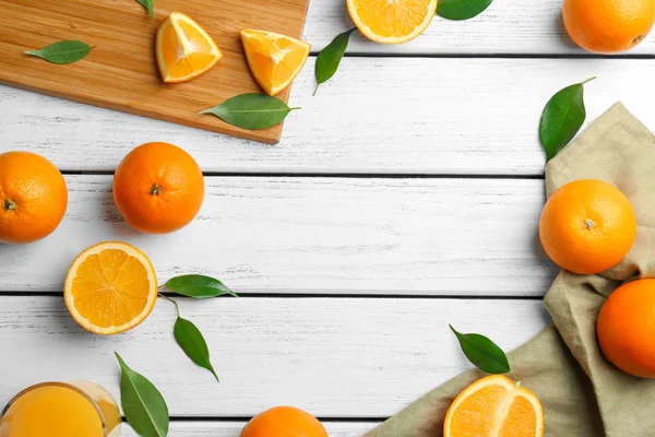 Juicy ripe oranges on wooden table — Stock Photo, Image