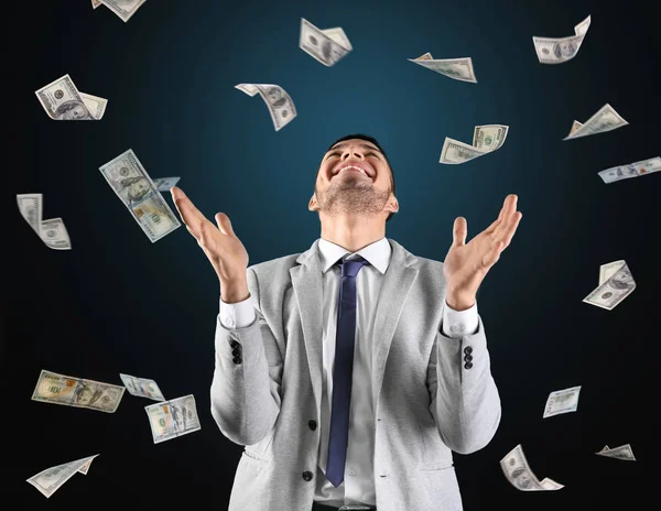 Successful stock broker with flying money on color background — Stock Photo, Image