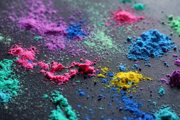Colorful powders for Holi festival on dark background — Stock Photo, Image