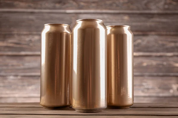 Cans of beer on wooden background