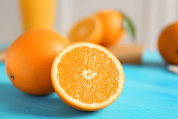 Fresh oranges on color wooden table — Stock Photo, Image