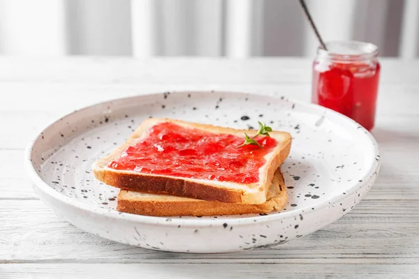 Delicious toast with sweet jam on plate — Stock Photo, Image
