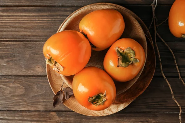 Tasty ripe persimmons — Stock Photo, Image