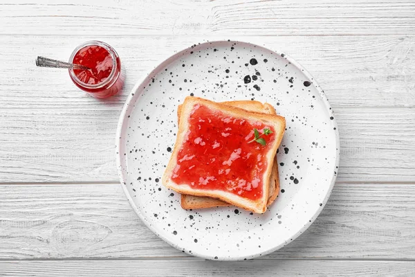 Delicious toast with sweet jam on plate — Stock Photo, Image