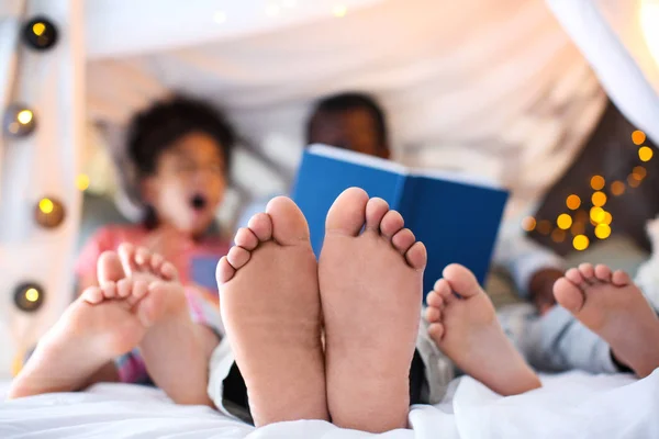 man reading bedtime story to children