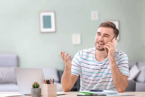 Young man in casual clothes at workplace