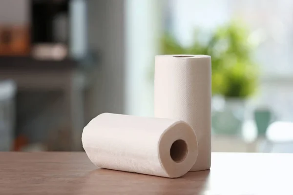 Rolls of paper towels on kitchen table — Stock Photo, Image