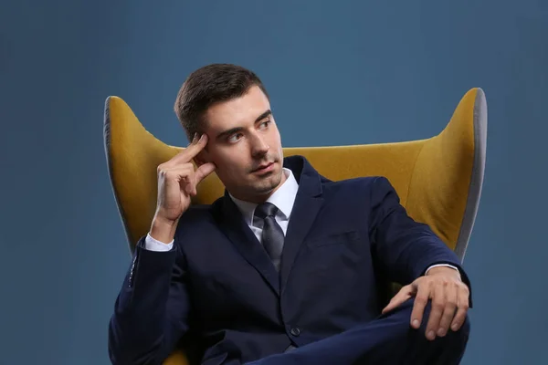 Man in elegant suit on color background — Stok Foto