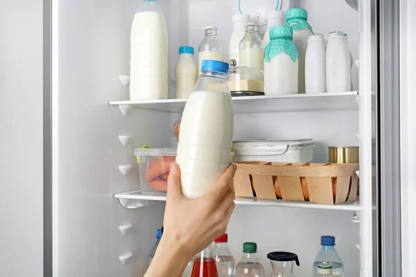 Молодая Женщина Берет Бутылку Молока Холодильника — стоковое фото