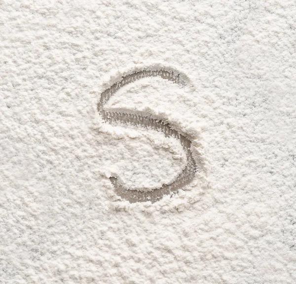 Letter S written on flour — Stock Photo, Image