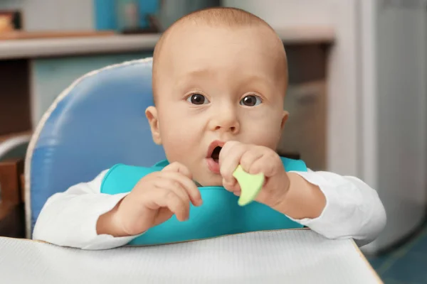 Lindo bebé con cuchara sentado en la cocina —  Fotos de Stock