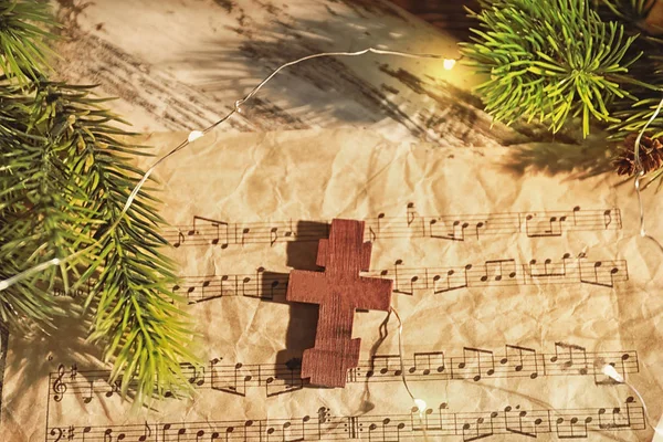 テーブルの上の木製十字架と音楽シート クリスマス組成 — ストック写真