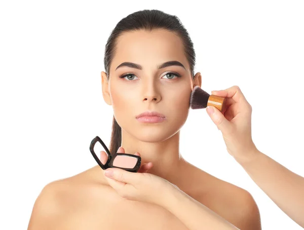 Professional visage artist applying makeup on woman's face against white background — Stock Photo, Image