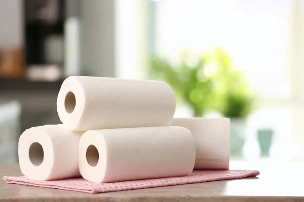 Rolls of paper towels on kitchen table — Stock Photo, Image