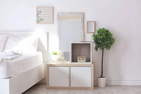 Cozy bedroom interior with shelving unit used as wardrobe — Stock Photo, Image