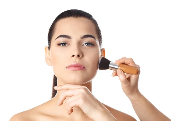 Professional visage artist applying makeup on woman's face against white background — Stock Photo, Image