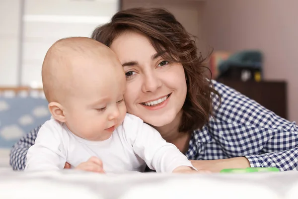Fiatal anya és a baba ágyon otthon — Stock Fotó