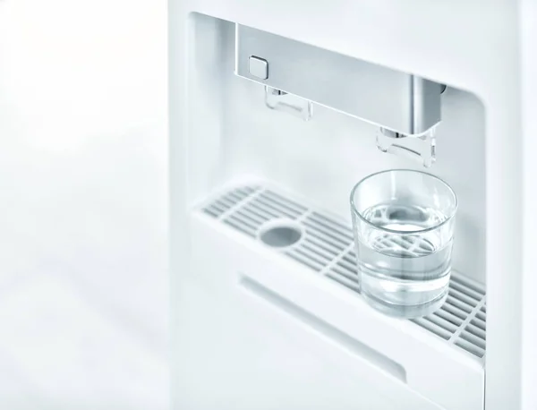 Modern water cooler with glass, closeup
