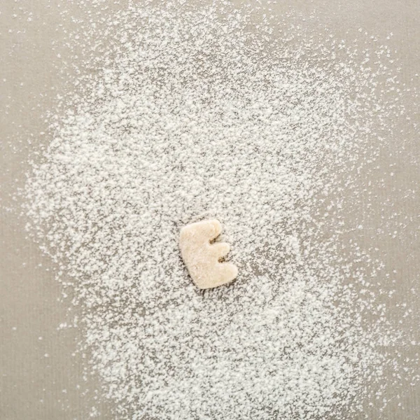 Letter E made of raw dough on flour — Stock Photo, Image