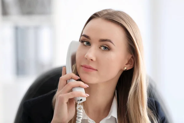 Beautiful woman talking on phone indoors — Stock Photo, Image