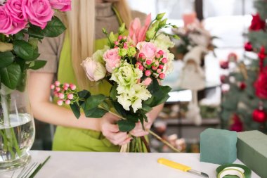 Kadın çiçekçi güzel buket çiçek dükkanında yapma
