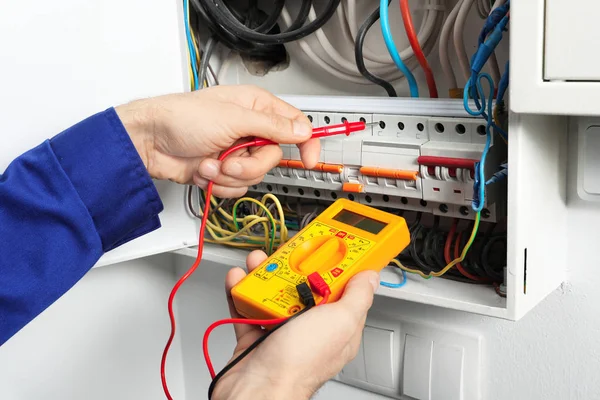 Young Electrician Measuring Voltage Distribution Board Closeup — Stock Photo, Image