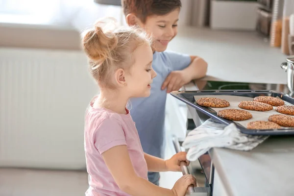 Little kids treating themselves to cookies. Fresh from oven — Stock Photo, Image