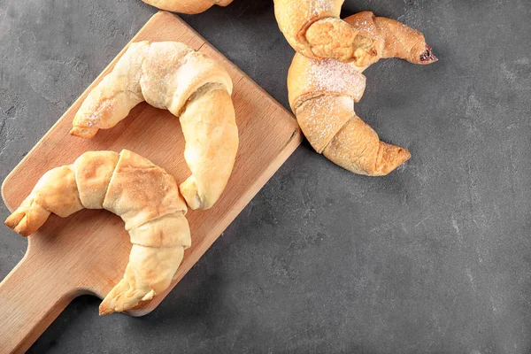 Wooden Board Tasty Crescent Rolls Grey Background — Stock Photo, Image